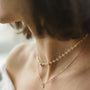 Stack of prayer beads on wooden surface, warm natural light