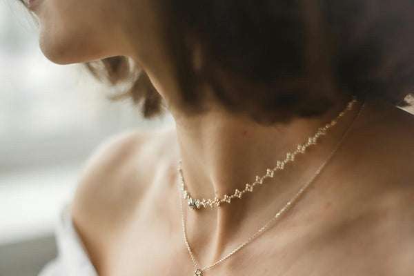 Stack of prayer beads on wooden surface, warm natural light