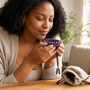 Black woman noticing the natural scent of purple Kenlina herbal incense beads beside a linen storage pouch