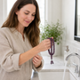 White woman removing purple Kenlina herbal incense beads before washing her hands
