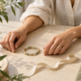 Conceptual illustration of two wrists with a loose bead bracelet and measuring tape between them